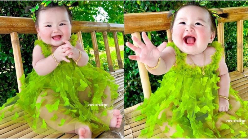 Cute Charm: Adorable Baby in Green Dress Captivates Hearts and Draws All Eyes